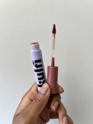 Swatches of the Kulfi Lassi Lips Staining Lip Oil on tan skin.