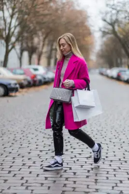 With a Bright Coat, Sweater, and Leather Pants