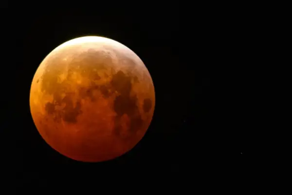 Image of a Wolf Moon In the Sky With Orange Tint
