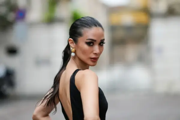 MILAN, ITALY - SEPTEMBER 20: Heart Evangelista wears a sleeveless black long mesh bodysuit with fluffy pants and floral embroidery, outside Roberto Cavalli, during the Milan Fashion Week - Womenswear Spring/Summer 2024 on September 20, 2023 in Milan, Ital