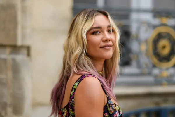 PARIS, FRANCE - JULY 05: Florence Pugh wears gold pendant earrings, a gold J