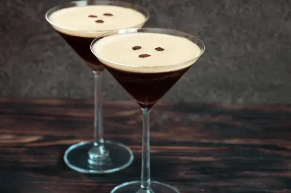 Two espresso martini cocktails garnished with coffee beans.