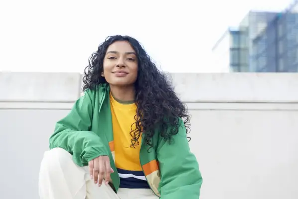 Woman On Rooftop Smiling at Camera