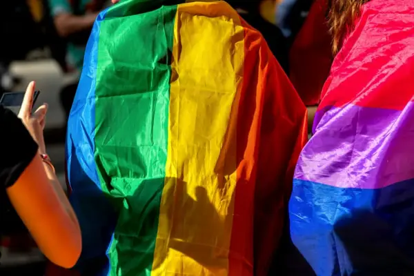 People celebrating Pride Month and Parade-People marching with the rainbow LGBTQ+ flag