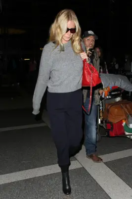 Gwyneth Paltrow Wearing a Gray Sweater and Red Bag
