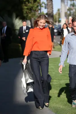 Gwyneth Paltrow Wearing an Orange Top and Jeans