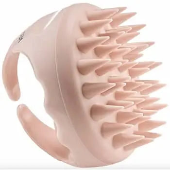 author with hair styled in a loose updo with curtain bangs