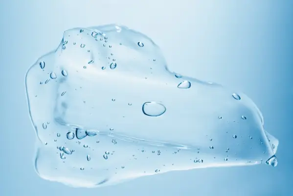 close up of clear lube puddle on a blue background