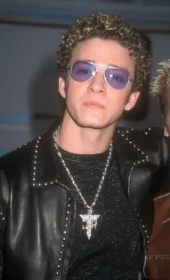 And With Long Curls and Tinted Aviators . . .