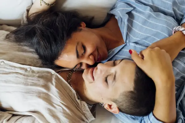 Couple of Lesbian Couple Embracing Each Other in Bed