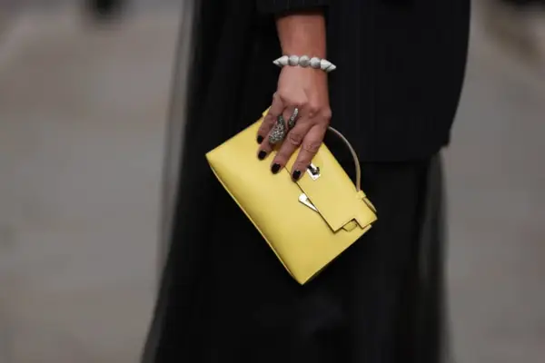 LONDON, ENGLAND - SEPTEMBER 17: Corina Mihaila Larpin is seen wearing bracelet and ring from Stéfère, a black pinstripe blazer with long tulle back from Monse and the Kelly bag from Hermès in yellow leather on September 17, 2023 in London, England. (Photo