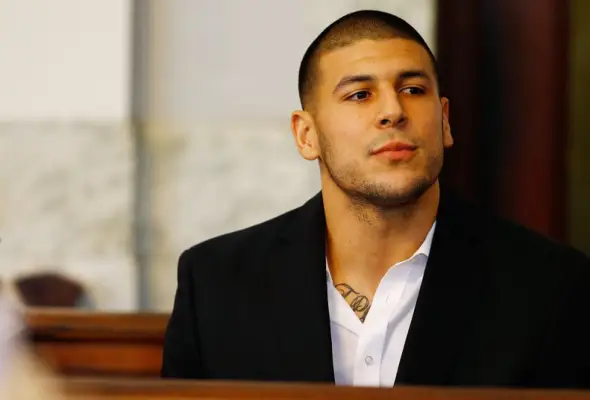 NORTH ATTLEBORO, MA - AUGUST 22: Aaron Hernandez sits in the courtroom of the Attleboro District Court during his hearing on August 22, 2013 in North Attleboro, Massachusetts. Former New England Patriot Aaron Hernandez has been indicted on a first-degree 