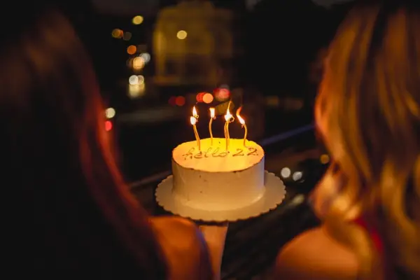Two Young Women Celebrating 22 Birthday With Cake and Candles
