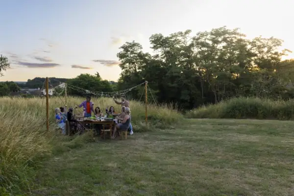 a group gathered for dinner outside on their family compound