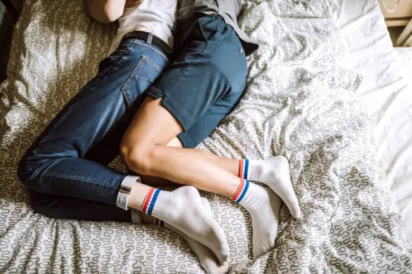 couple in bed in spooning sex position