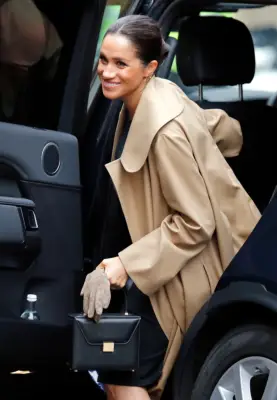 ‎Meghan Markle Carrying a Victoria Beckham Vanity Top Handle Box Bag in Black