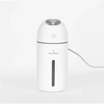 hey dewy portable facial humidifier on a nightstand