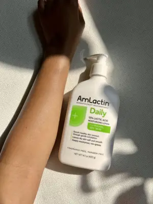 The AmLactin Daily Lotion next to woman