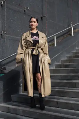 With a T-shirt Dress, Fishnet Tights, and Black Ankle Boots