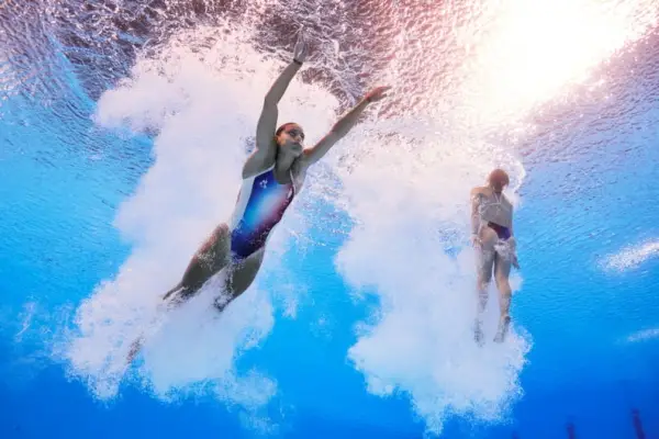 PARIS, FRANCE - JULY 27: (EDITORS NOTE: Image was captured using an underwater robotic camera.) Nais Gillet and Juliette Landi of Team France compete in the Women