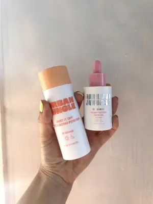 A photo shows a hand holding two Urban Jungle skin-care products.