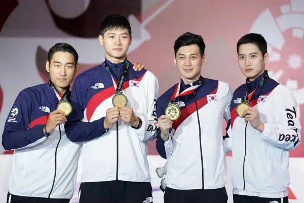 JAKARTA, INDONESIA - AUGUST 23: Sanguk Oh; Bongil Gu; Junho Kim and Bongil Gu of Korea pose on the podium during the awards ceremony in Fencing Men