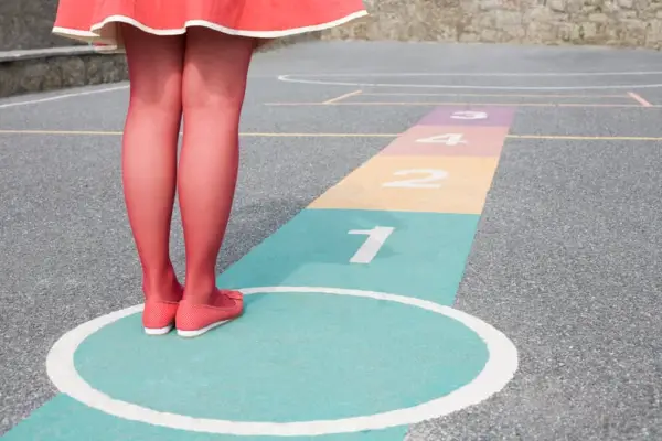 Draw a hopscotch board with chalk and play (you